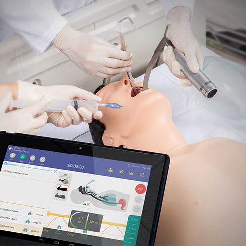 person practicing intubation on a manikin with feedback on tablet