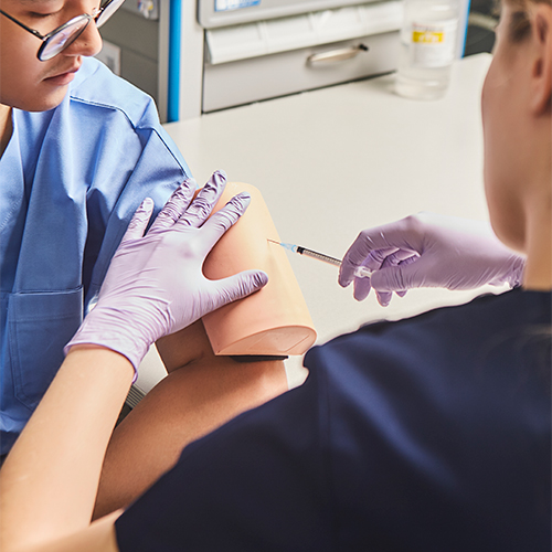 person practicing injections on a wearable skill trainer