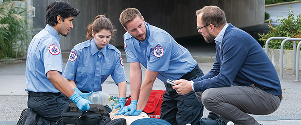 EMS students practicing on manikin