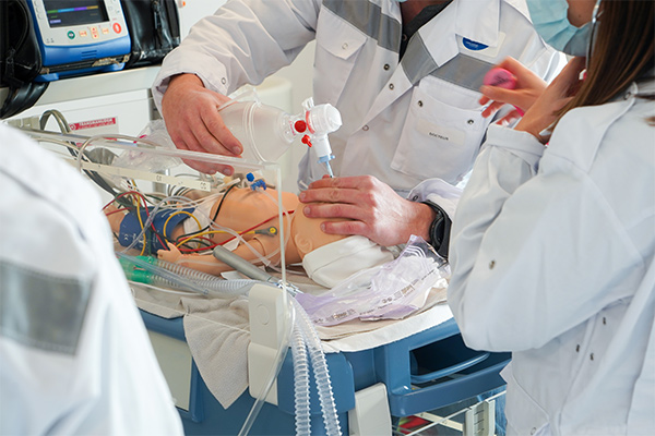 infant simulator hooked up to 12-lead EKG