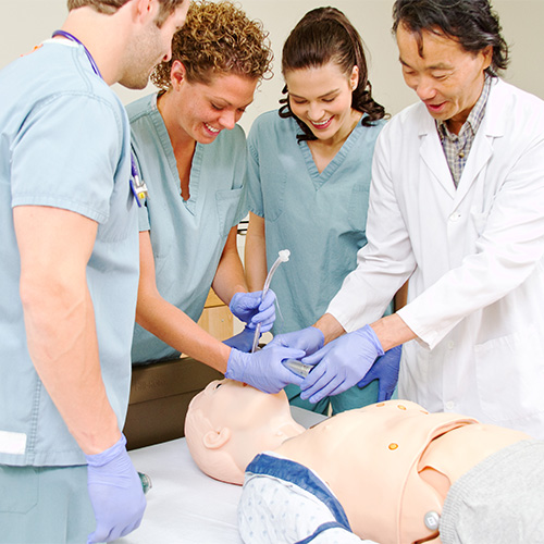 medical students practicing intubation on a manikin
