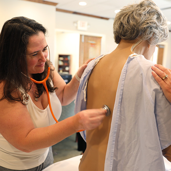 female student practicing IM injection