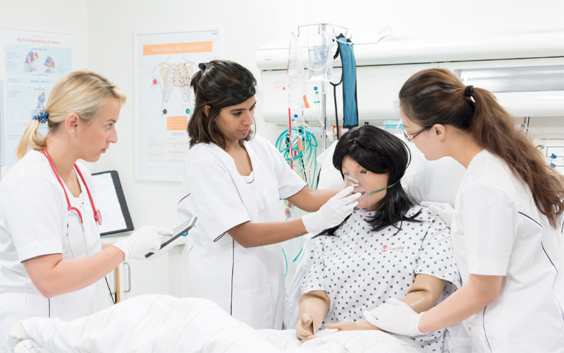 nursing students working with a Nursing Anne manikin