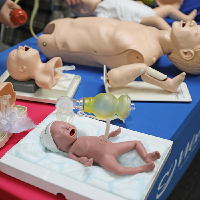 Variety of Laerdal skill trainers on a table
