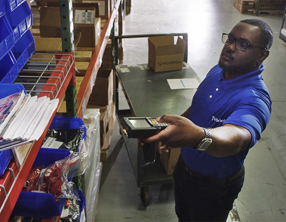 WorldPoint warehouse employee scanning in-stock product from a shelf