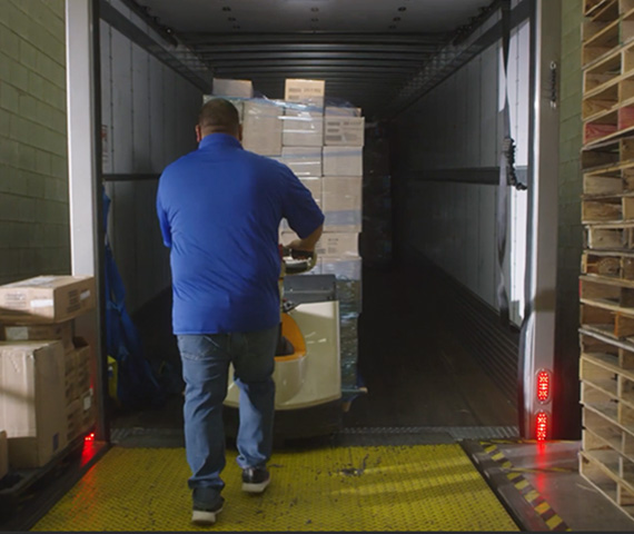 WorldPoint warehouse employee removing products from a shipping truck