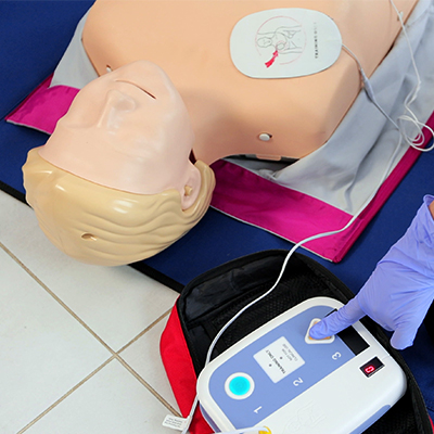 Laerdal Little Anne CPR manikin with AED pads applied