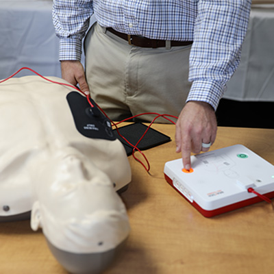 Man performing CPR on CPR Taylor manikin