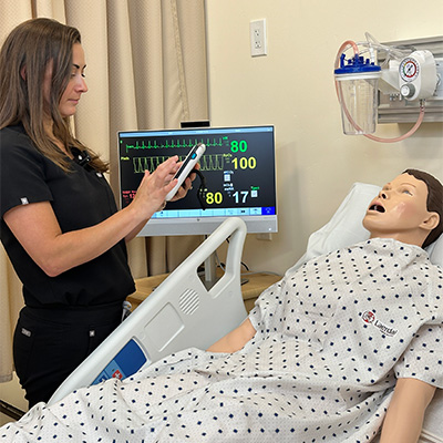 Nurse using SimPad Plus with Nursing Anne manikin