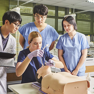 Man performing CPR on CPR Taylor manikin